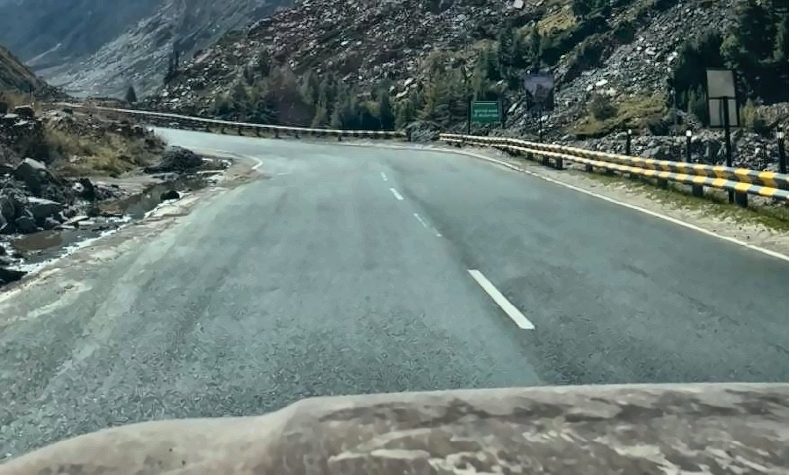 Empty mountain highway seen over the bonnet of the Thar